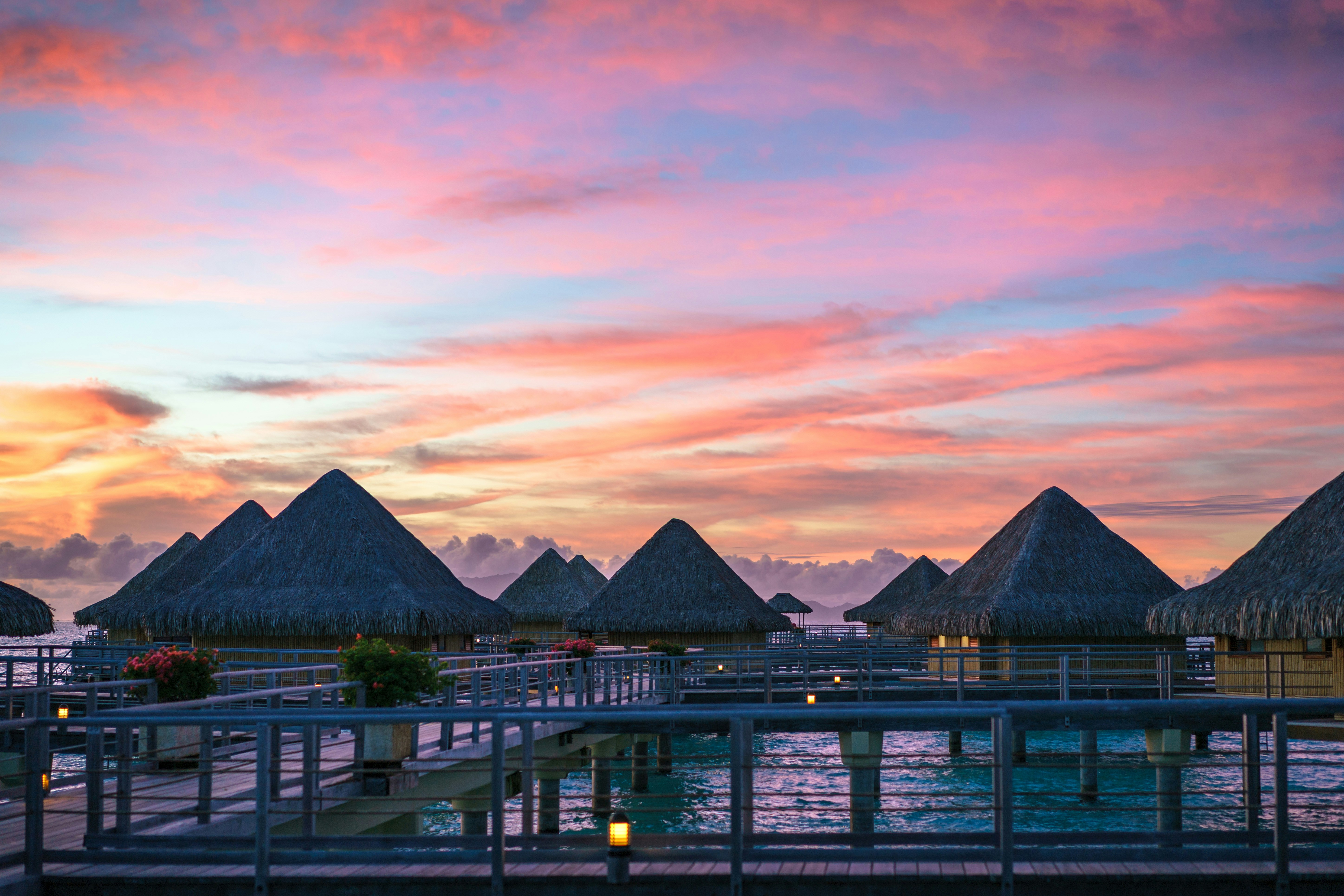 Overwater bungalow and colorful sky in Bora Bora